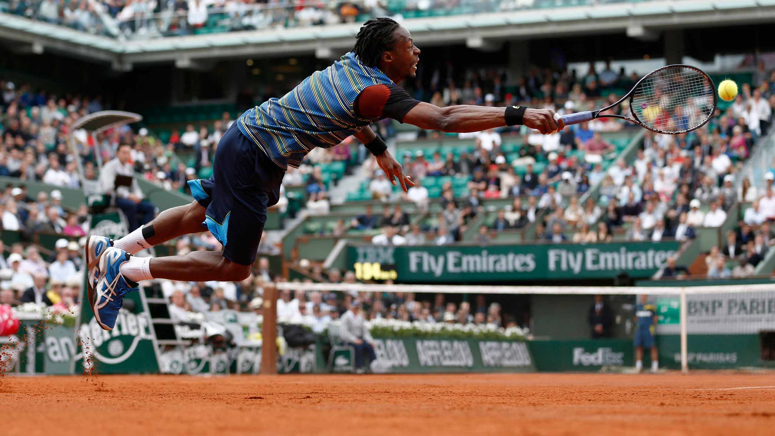 Gael Monfils dives for a ball at Roland Garros, where he has created countless memories for fans.