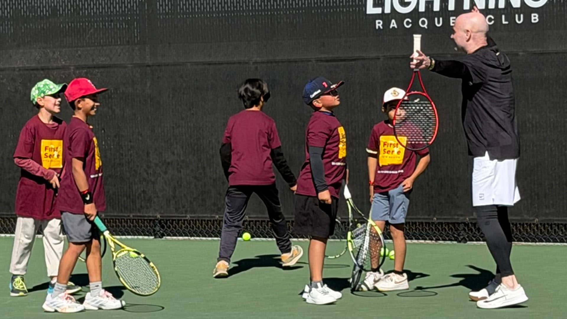 Andre Agassi with young tennis athletes at the Forked Lightning Racquet Club in Santa Fe, New Mexico.